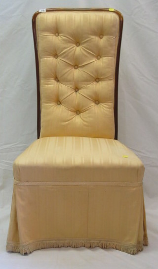A Victorian walnutwood show frame nursing chair upholstered cream striped material