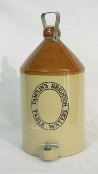 A stoneware flagon with iron handle and spicket marked Tamplins Brighton Table Water