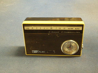 A Russian Uega Ruby portable transistor radio set  a clock contained in a black and white plastic case