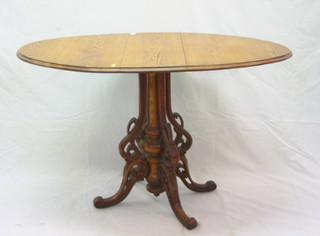 A 19th Century Continental pine oval drop flap pedestal occasional table, raised on a pierced turned column 24" 