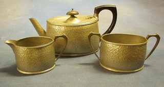 A Unity planished pewter 3 piece tea service with teapot, cream jug and sugar bowl