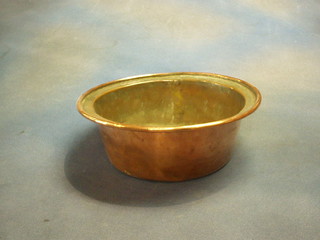 A circular copper bowl 11"