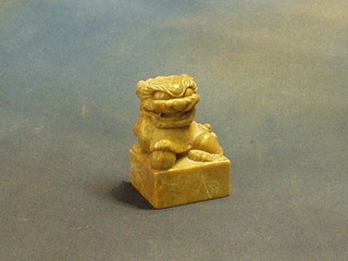 An Oriental carved soap stone seal in the form of a seated dog of fo 3 1/2