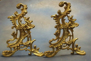 2 modern pierced brass fire dogs and a circular pierced brass trivet