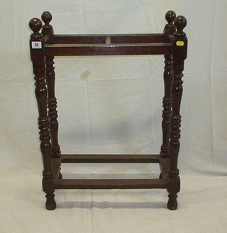 A late Victorian turned oak umbrella stand, raised on turned and block supports 21" (no drip tray)
