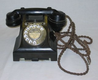 A black Bakelite dial telephone