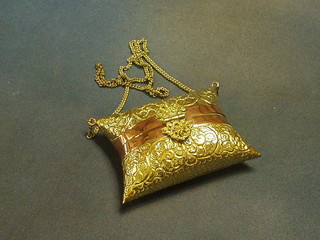 An Eastern embossed brass and copper cushion shaped purse 5"