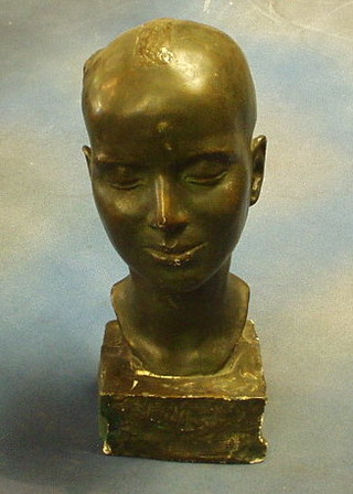 An Art Nouveau verdigris plaster head and shoulder portrait bust signed DE Herain 1929, raised on a rocky base, 16"