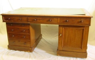 A pedestal desk with inset tooled leather writing surface above 1 long and 6 drawers (1 pedestal fitted a cupboard) 61"