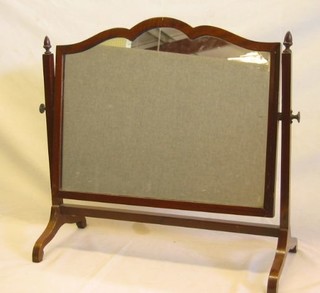 A shaped plated dressing table mirror contained in a mahogany swing frame