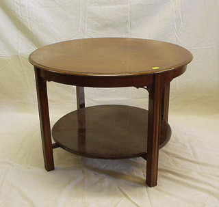 An Edwardian Chippendale style mahogany circular 2 tier occasional table on square tapering supports 30"