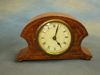 A 1930's bedroom timepiece contained in a shaped inlaid mahogany case