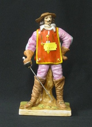 A porcelain figure of a standing musketeer with drawn sword, 8"