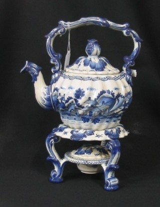 A 19th Century blue and white pottery tea kettle, the base marked B815 raised on a stand (stand r)