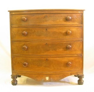 A 19th Century mahogany bow front chest of 4 long drawers, inlaid satinwood stringing, raised on turned supports 40"