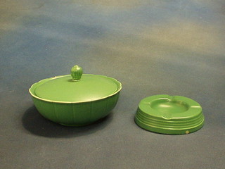 A green Wedgwood Keith Murray powder bowl and cover, the base marked Keith Murray Wedgwood Made in England, (4 small chips to the rim) 6" and a circular Wedgwood green glazed Keith Murray ashtray 4 1/" (2 small chips)