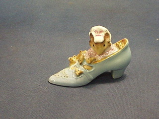 A Beswick Beatrix Potter figure "The Old Woman Who Lived in the Shoe", base with gold back stamp (mice's ears chipped)