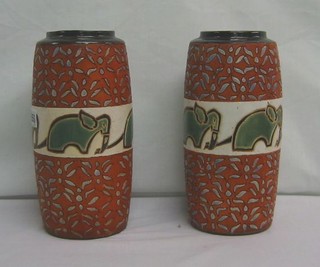 A pair of pottery vases decorated elephants 11"