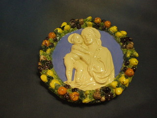 A circular Majolica wall plaque decorated the Virgin Mary and child, reverse marked 226 Made in Italy 13"