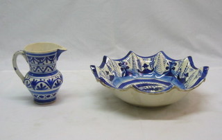 A 19th Century "Quimper" blue and white pottery dish with scalloped edge 11" and a similar jug 5"