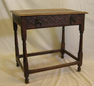 An 18th/19th Century carved oak side table fitted a frieze drawer with brass lion mask handles raised on turned and block supports  29"