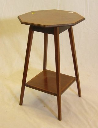 An Edwardian octagonal inlaid mahogany 2 tier occasional table raised on square tapering supports 17"
