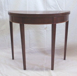 A Georgian mahogany demi-lune card table, raised on square tapering supports 35"