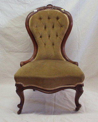 A Victorian carved walnutwood spoon back chair, upholstered yellow buttoned material on cabriole supports