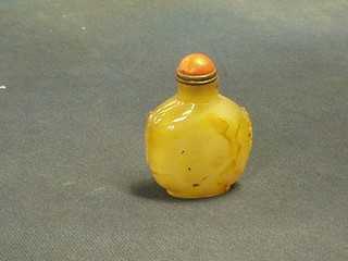 An Oriental carved hardstone snuff bottle with "coral" topped spoon