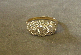 A lady's gold triple cluster dress ring set 3 diamond surrounded by numerous diamonds (approx 1.23ct)
