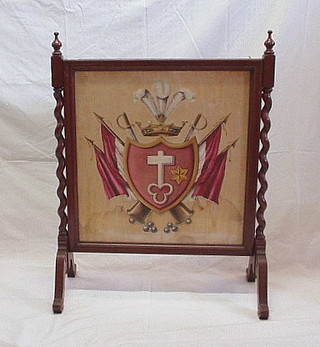 A Victorian walnutwood fire screen with spiral turned columns to the side, the centre panel decorated military trophies 28"