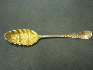 A Georgian silver gilt berry spoon