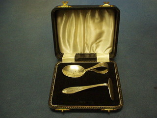 A childs 2 piece silver spoon and pusher Birmingham 1957 and 1962, cased