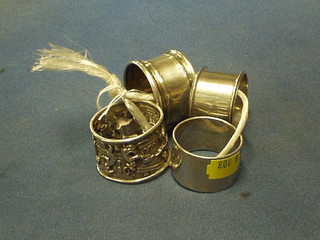 An embossed silver napkin ring decorated kitchen scene, Sheffield 1908 and 2 other silver napkin rings and 1 other