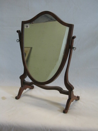 A shield shape dressing table mirror contained in a mahogany swing frame