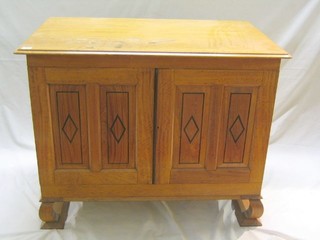 A Continental satinwood linen press of small proportions, the interior fitted 2 short and 2 long drawers enclosed by panelled doors, raised on ogee bracket feet 39"