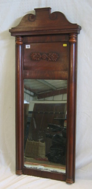 A rectangular 19th Century plate mirror contained in a mahogany frame flanked by a pair of columns