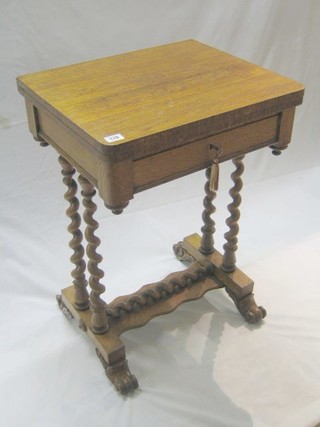 A Victorian light oak games table with swivel top, the base fitted a drawer, raised on spiral turned supports 20"