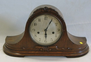 A 1930's striking mantel clock contained in an oak "Admiral's hat" case