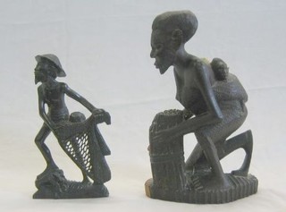 An Eastern carved figure of a seated man with child 12" and 1 other Fisherman 10"