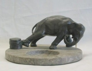 An Art Deco and marble bronze ashtray in the form of a chained elephant by an oasis, on a veined grey marble base, 9"