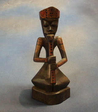 A carved African figure of a musician 12"