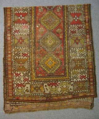 A Caucasian rug, 7 octagons to the centre within multi-row border 101" x 45"