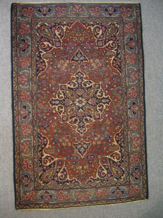 A Tabriz rug with peach ground and central medallion within multi row borders 51" x 34" (some wear)