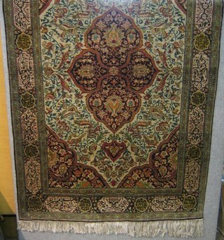 A fine quality Ghoum carpet with central medallion, decorated birds amidst flowering branches within multi-row borders 89" x 53"
