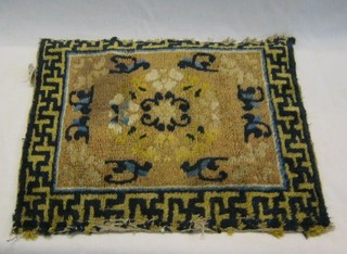 A small Oriental yellow ground rug decorated flowers and monkeys within Grecian key border, 28" x 20"