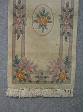 A 1930's green ground and floral patterned Chinese rug 71" x 36"