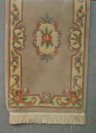 A peach coloured and floral patterned Chinese rug 49" x 28"