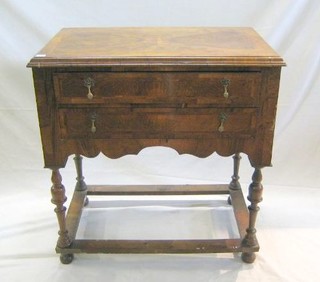 A "Queen Anne" figured "walnutwood" chest with feather banded top and caddy moulding, fitted 2 long drawers, raised on turned supports with box frame stretcher 36" 