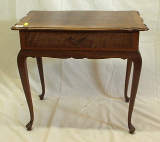 A Continental shaped walnutwood side table fitted a frieze drawer, raised on cabriole supports 24"